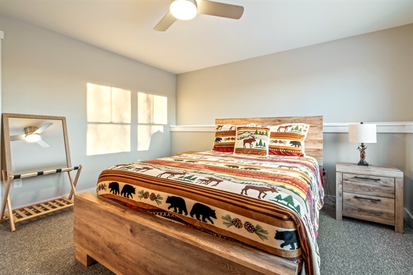 Relax in the basement bedroom with a cozy queen bed and added privacy.