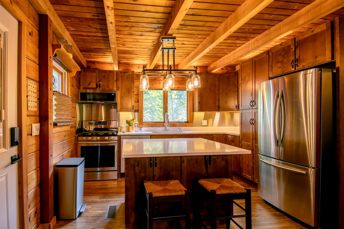 Kitchen with quartz counters, island with breakfast bar, stainless backsplash, reverse osmosis, spices and ample kitchen supplies. Ask host if you want to make sure the kitchen is quipped with what you need.