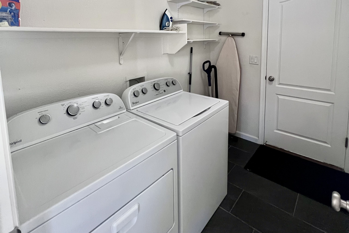Enjoy the convenience of a private laundry room with a full-size washer and dryer