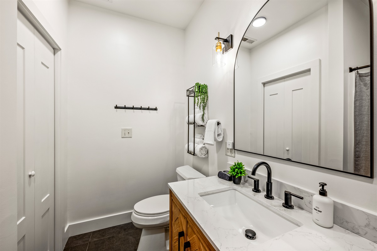 Enjoy clean lines and calm simplicity in this modern bathroom with a tub/shower combo and full amenities for comfort and ease.