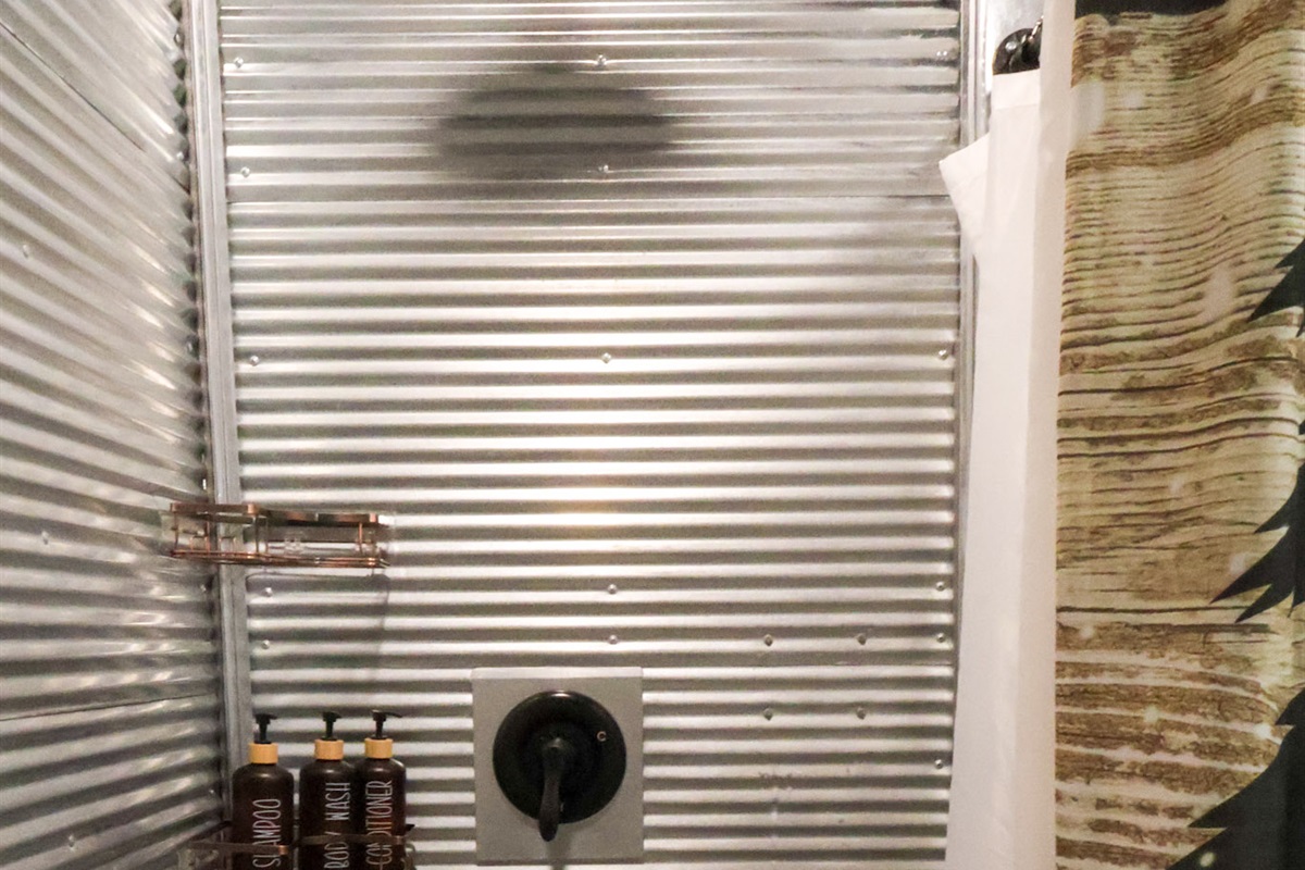 Surrounded by faux tin w/ a rainshower head. Plenty of room for two people