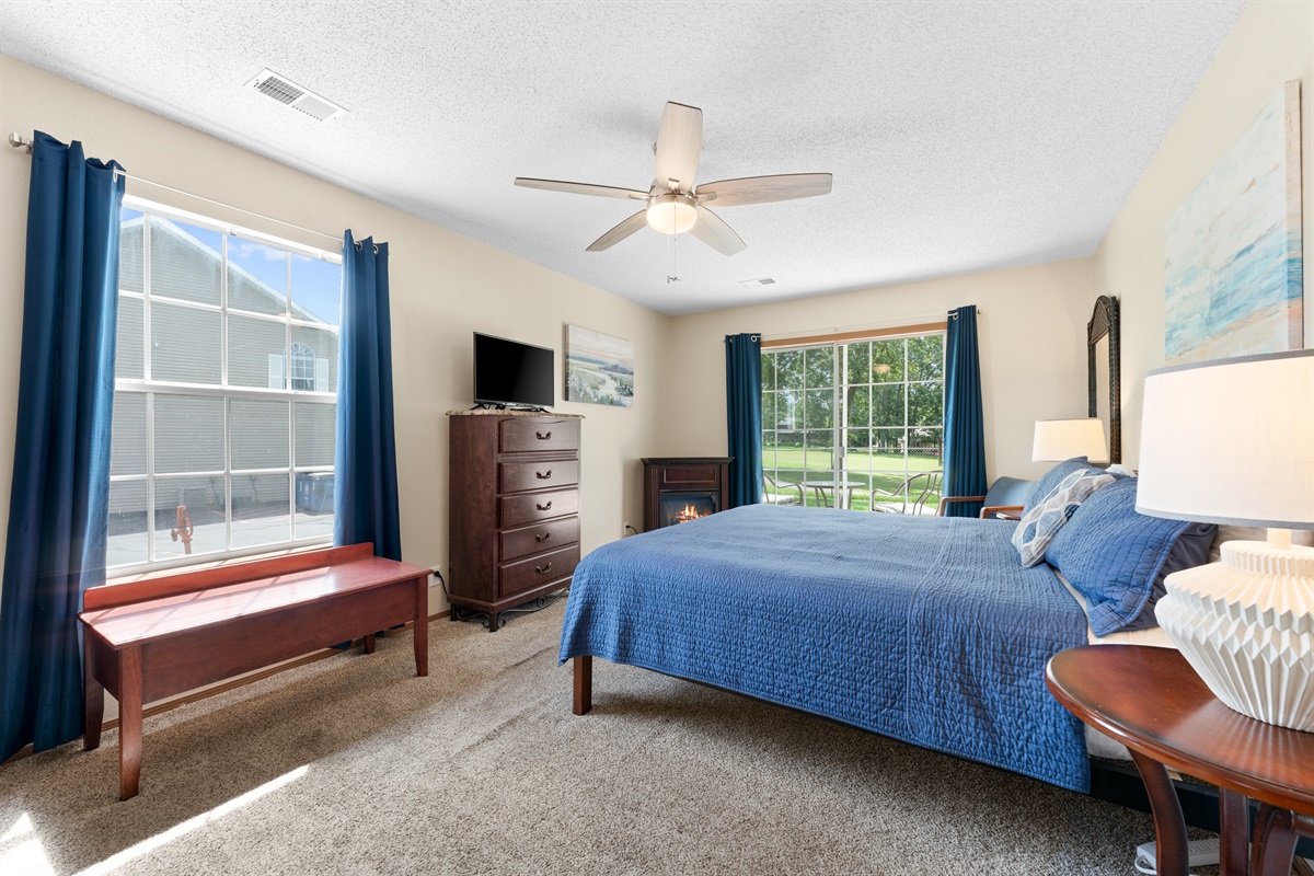 Spacious primary suite with king bed, fireplace, and golf course views.