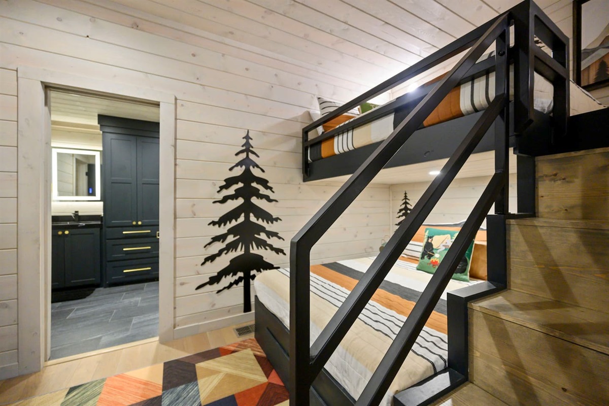 Bunk room features custom iron railings for safety.