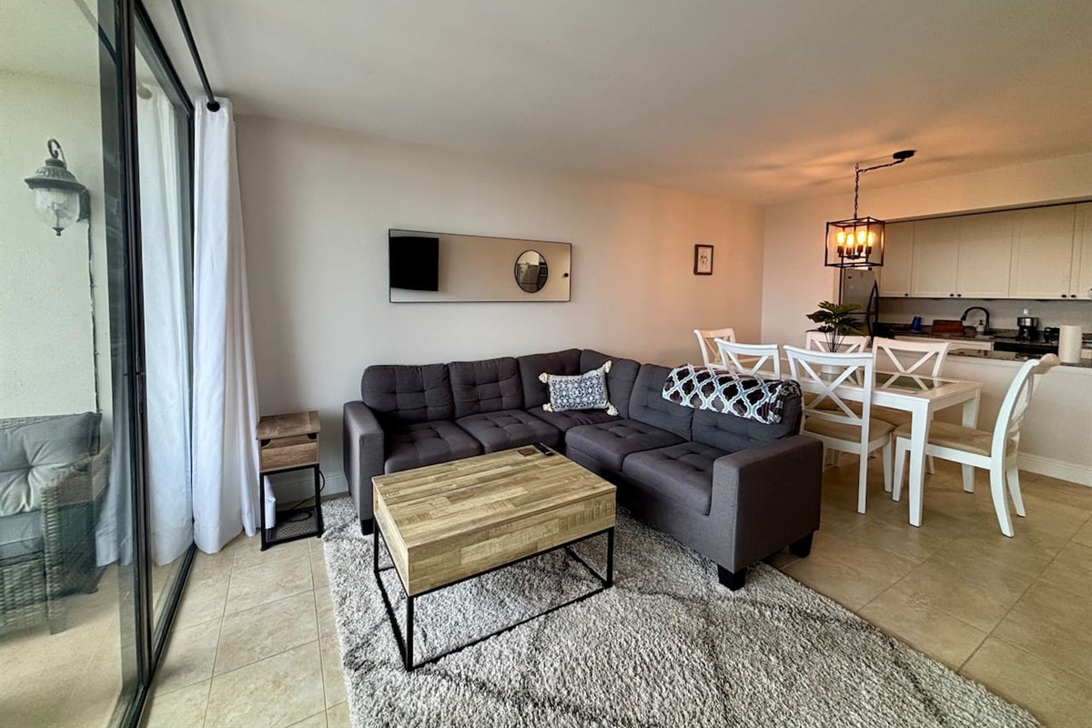 A large TV and comfortable couch is yours to enjoy throughout your stay.