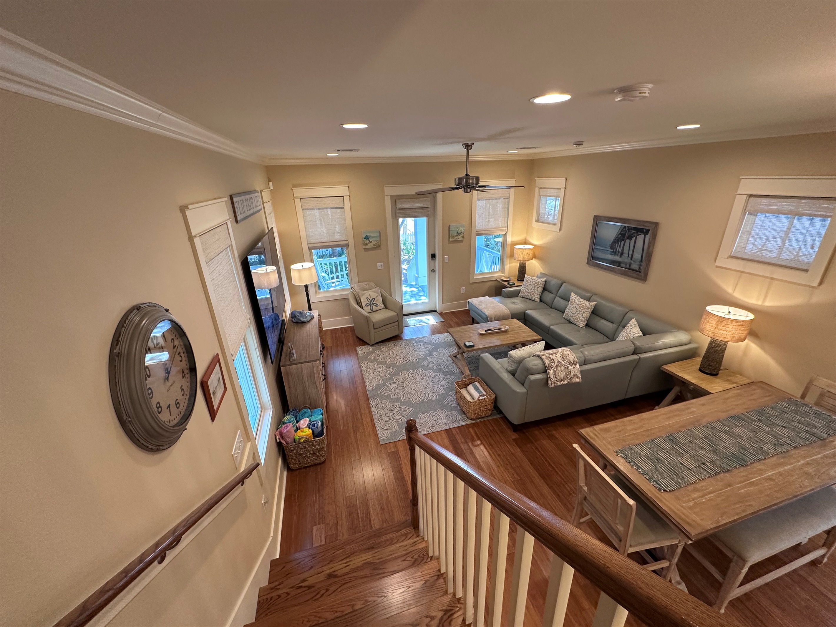 Living Room and Dining Area view from stairs, looking out onto private front porch.
