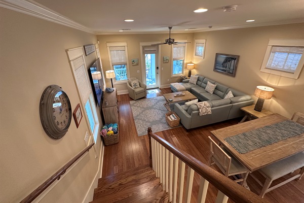 Living Room and Dining Area view from stairs, looking out onto front porch.  