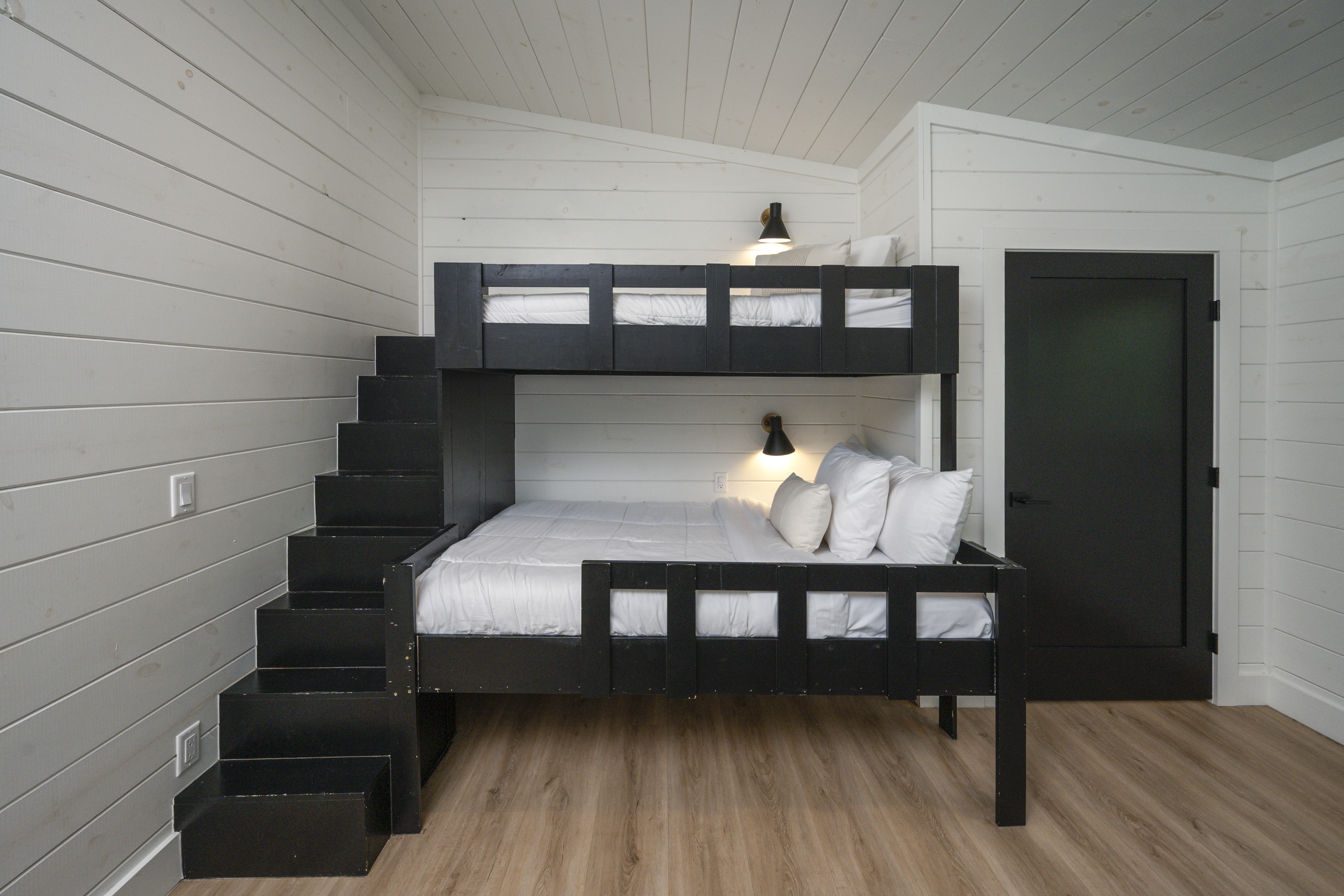 Custom bunk beds with built-in stairs create a fun, comfortable retreat for kids and teens.