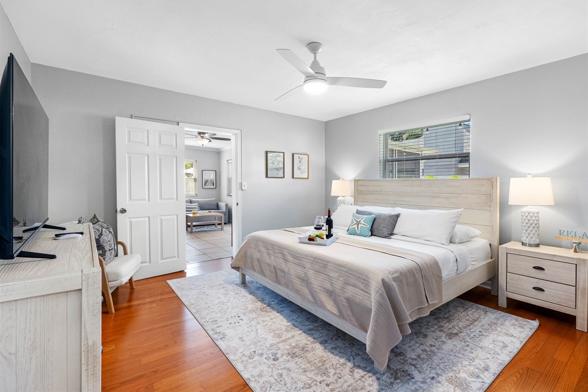Coastal elegance meets comfort in this serene master suite with a king bed, soft textures, and soothing tones.