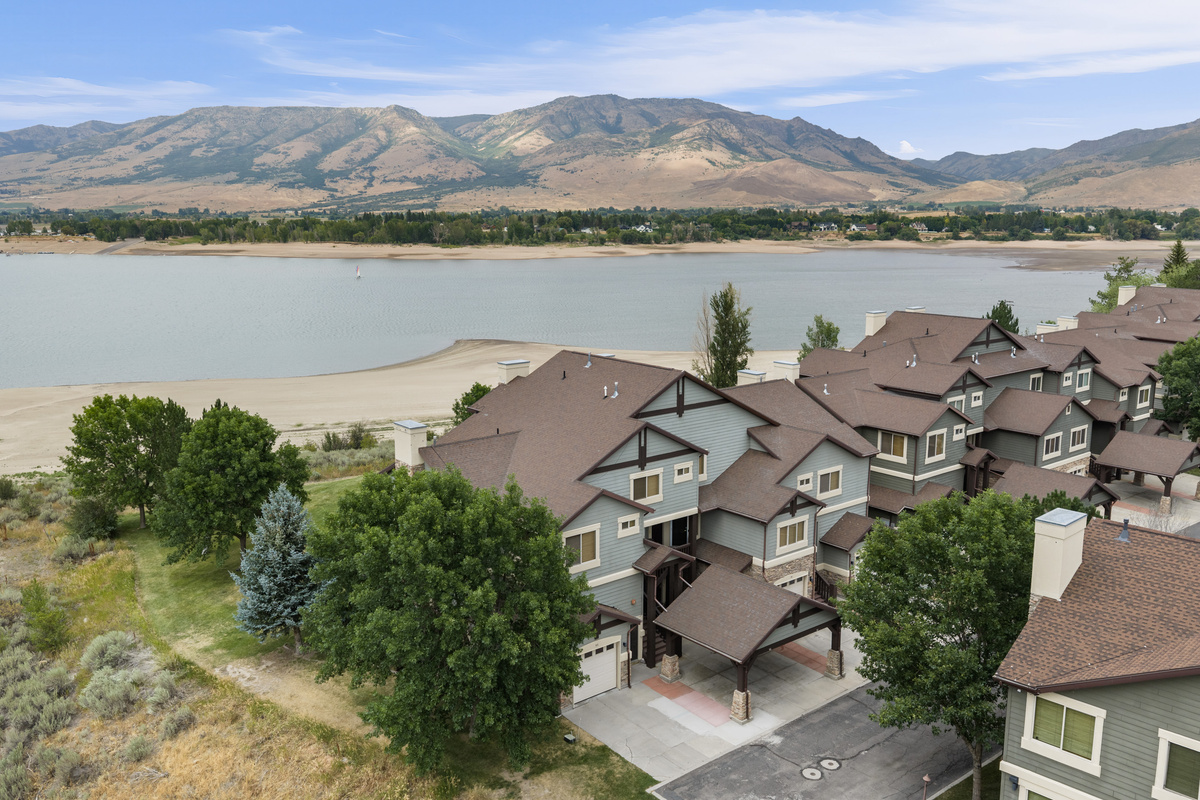 Beautiful aerial view showcasing the home’s Lakeside Village location along Pineview Reservoir and surrounded by mountain scenery.