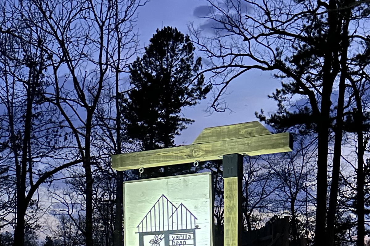 You won't miss us with our original Vanilla Bean Cabin sign with landscape lighting as the sun sets!