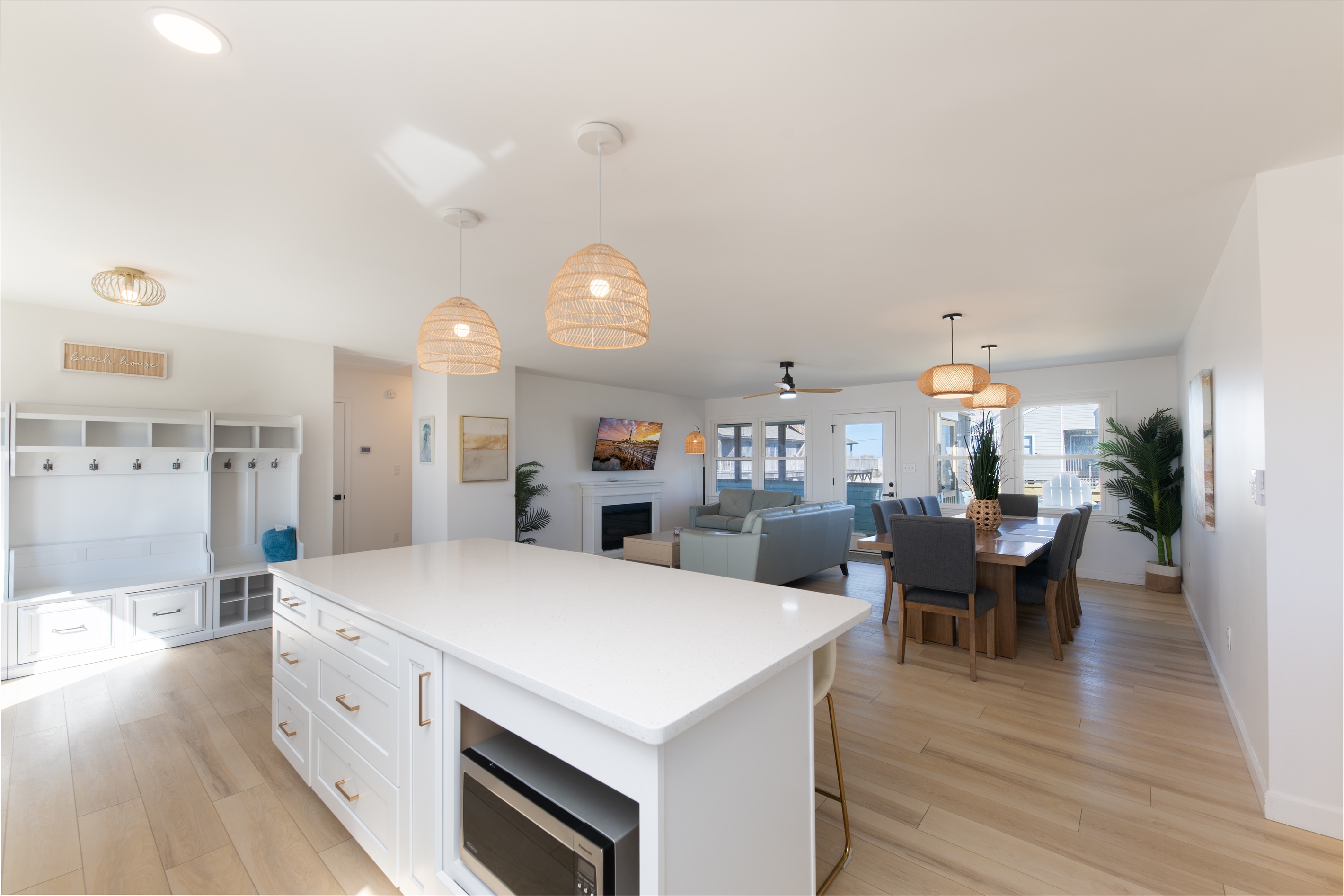 Open floor plan with a large dining area, island, and TV area