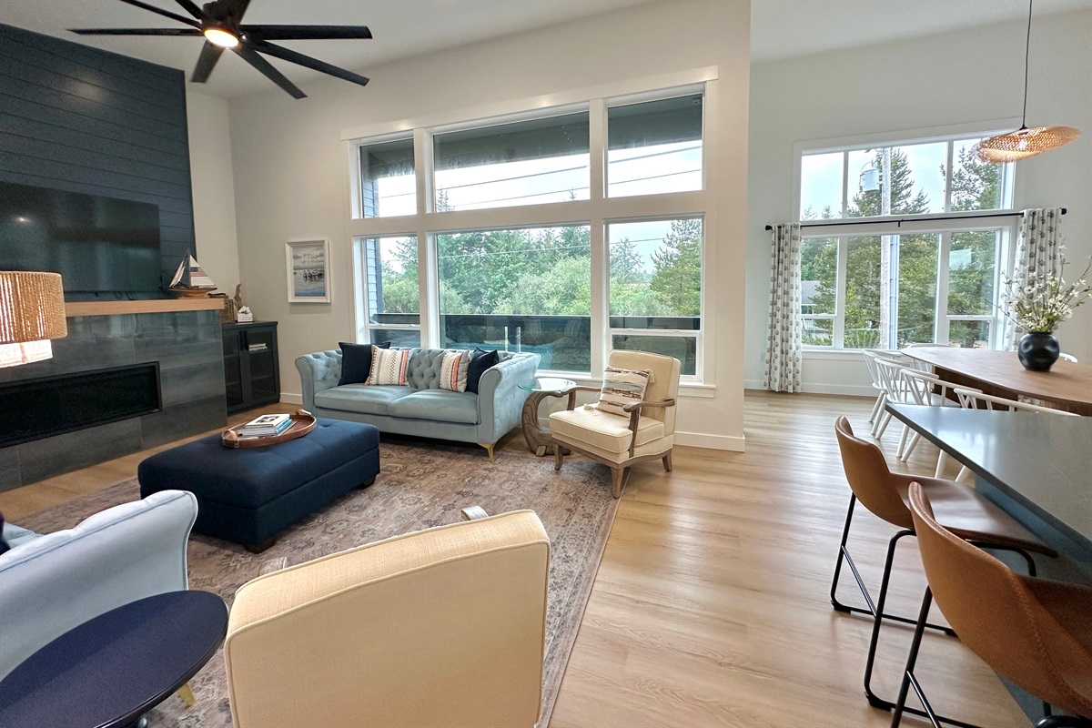 The upstairs living area has soaring ceilings with natural light for days.  It's a large comfortable space for everyone to relax, cook, and eat.   