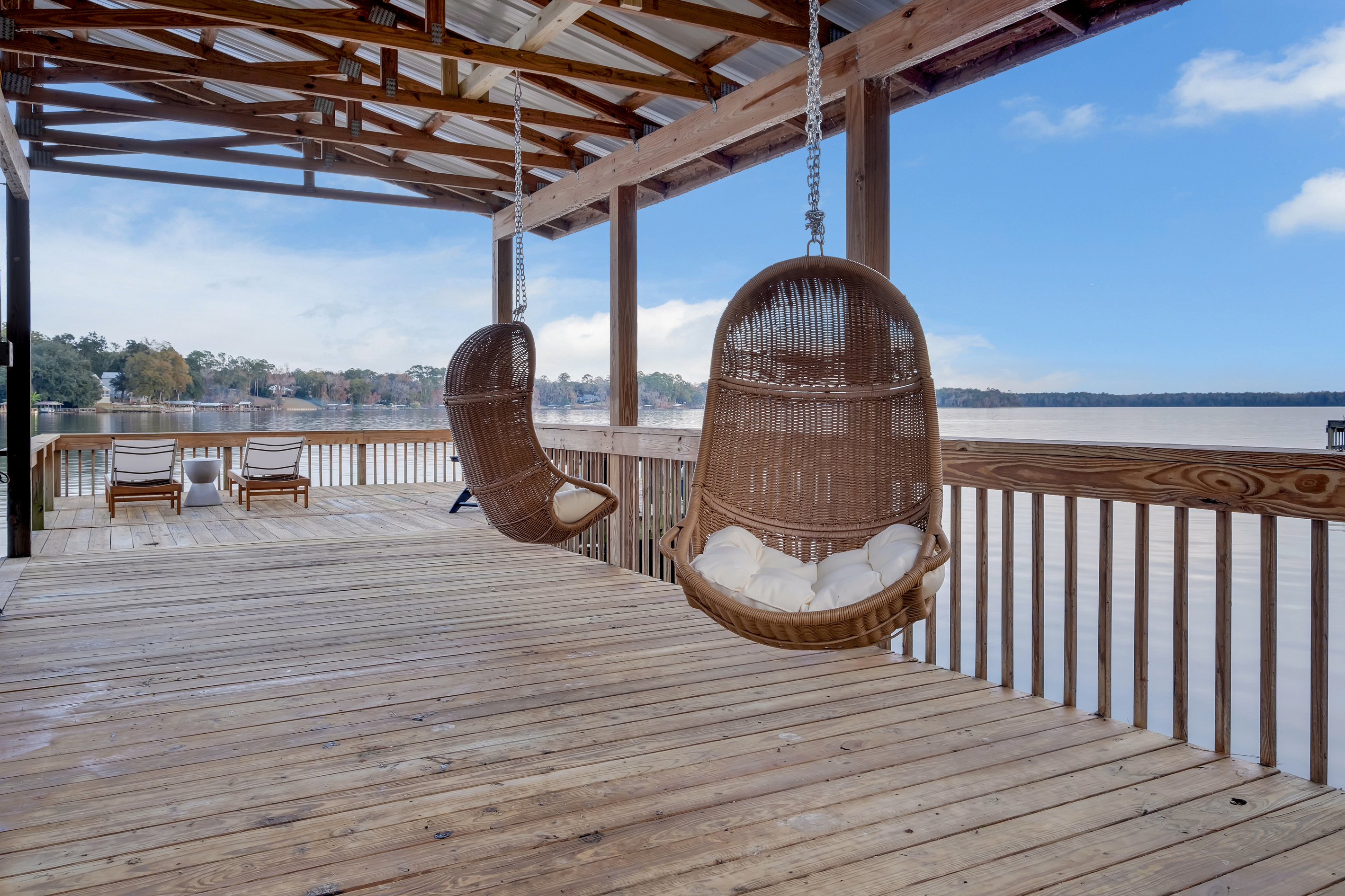 Hanging swing chairs in the covered boathouse