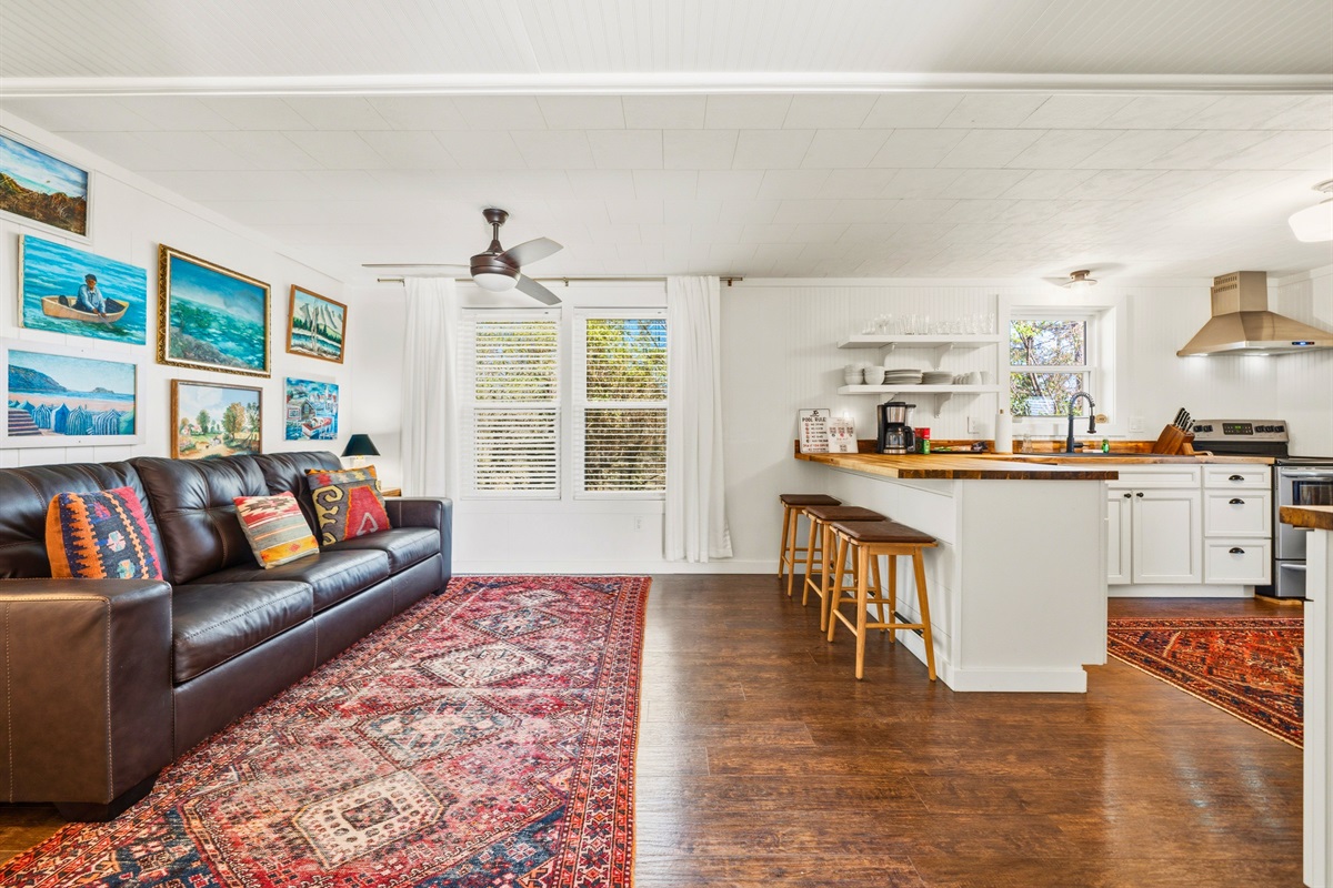 Step inside the guest house living area where comfortable seating and colorful accents create a relaxed and welcoming place to gather.