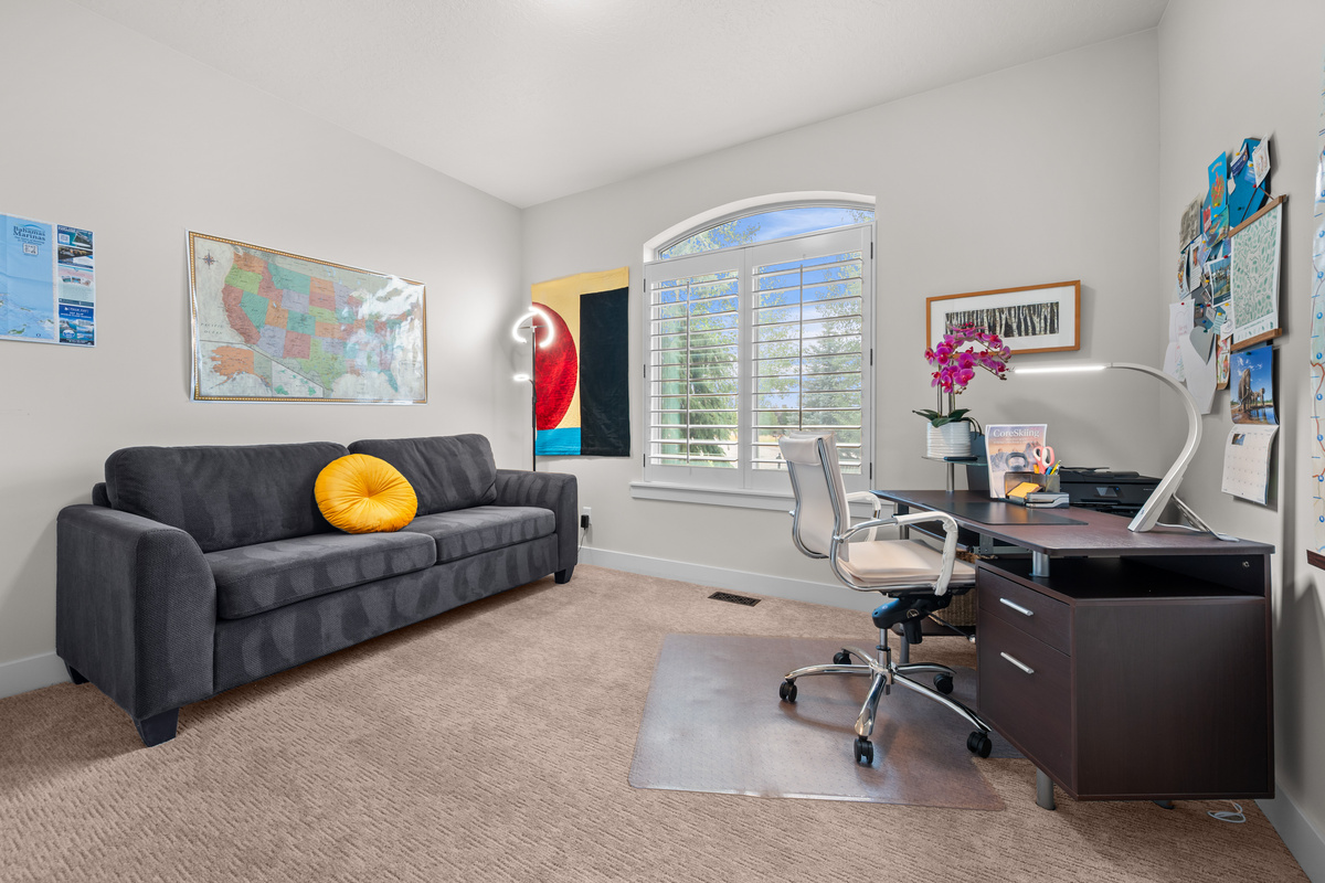 Flexible main-level office and guest room featuring a queen sleeper sofa — ideal for remote work or extra guests.