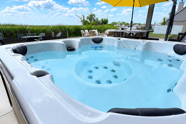 Relax in this inviting outdoor hot tub, perfectly set on a private waterfront patio. Surrounded by serene views and open sky, it’s the ideal spot to unwind after a day of exploring, offering a peaceful spa-like experience in a beautiful canal-side setting.