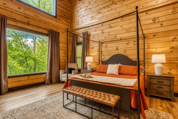 Wake up to soft morning light and peaceful forest views from this cozy, sunlit bedroom