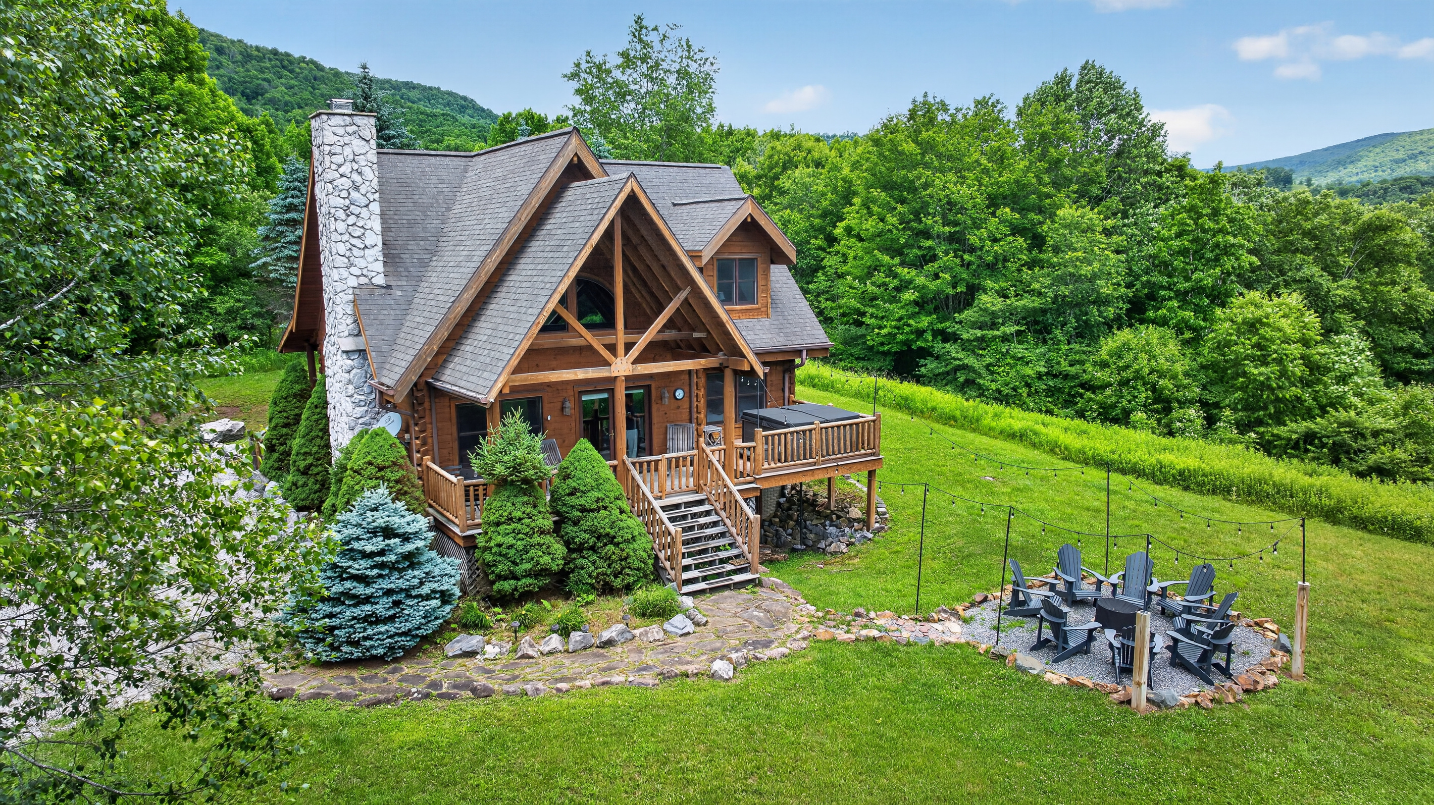 Front porch with rocking chairs, a hot tub, and fire pit just steps away. 