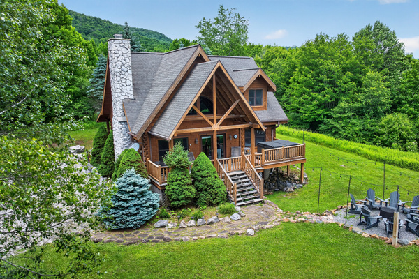 Front porch with rocking chairs, a hot tub, and fire pit just steps away. 