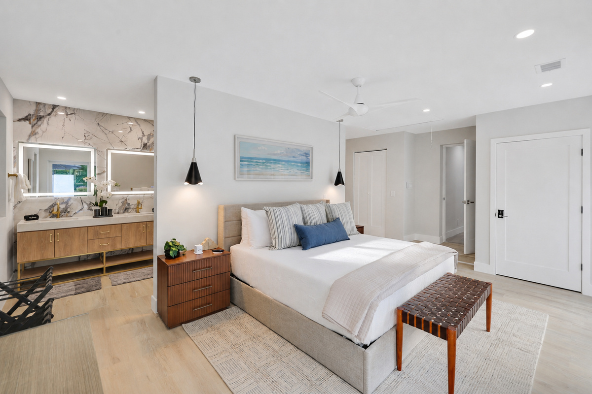 This spacious king suite connects naturally to the vanity and bath area, giving guests comfort, privacy, and room to settle in.