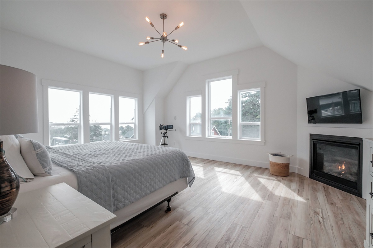 A serene primary bedroom with vaulted ceilings and natural light, offering a peaceful retreat to unwind.
