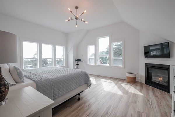 A serene primary bedroom with vaulted ceilings and natural light, offering a peaceful retreat to unwind.