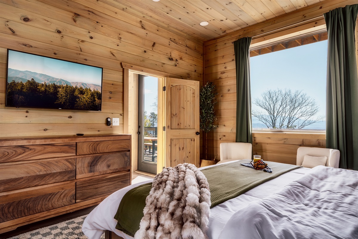 Sunny bedroom with scenic light and a TV. Perfect for slow mornings.
