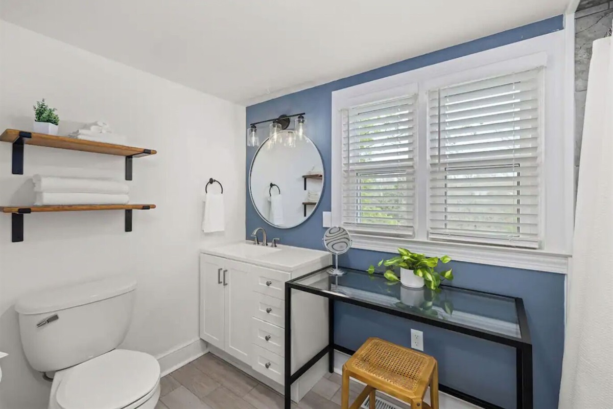 Magnolia Suite full bathroom includes a sink, toilet, tile shower, and vanity