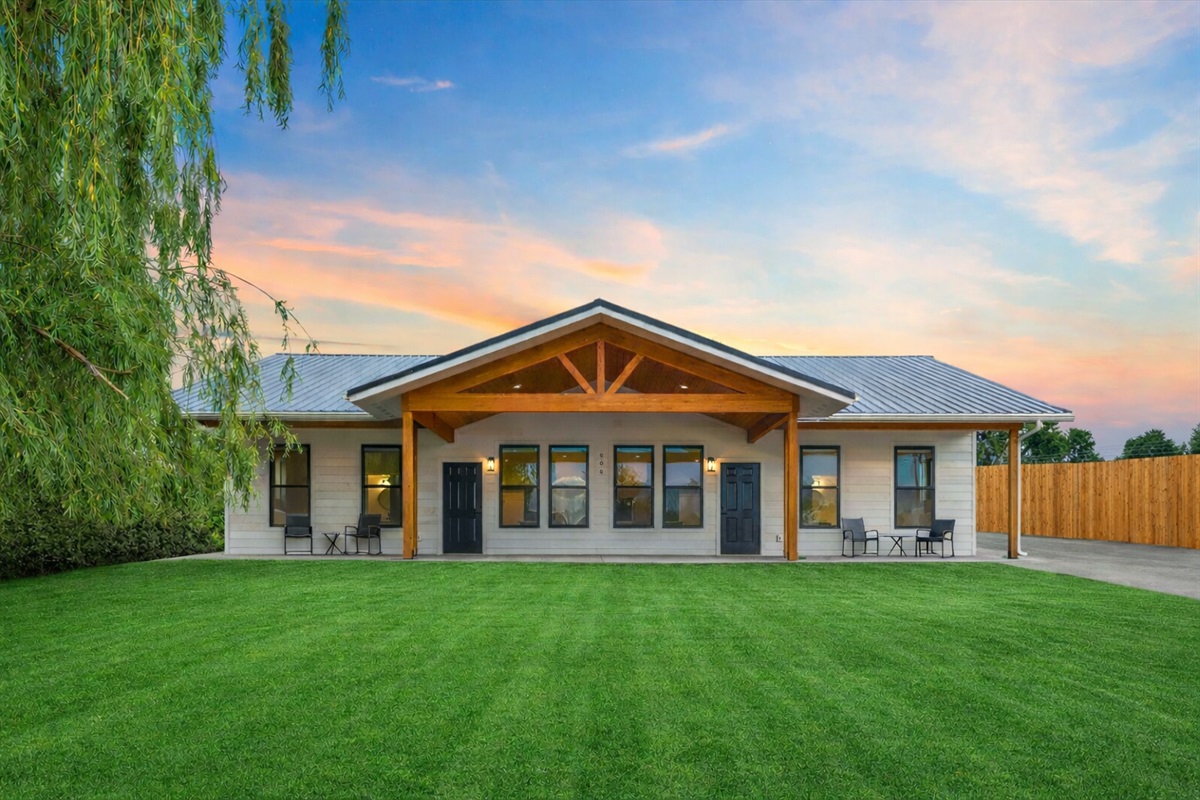 Modern duplex with large front patio for your morning coffee and parking along the easement. (grass enhanced w/ AI)