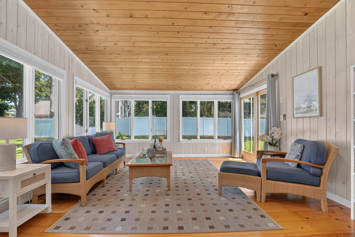 Bright and airy sunroom with comfortable seating for every season.
