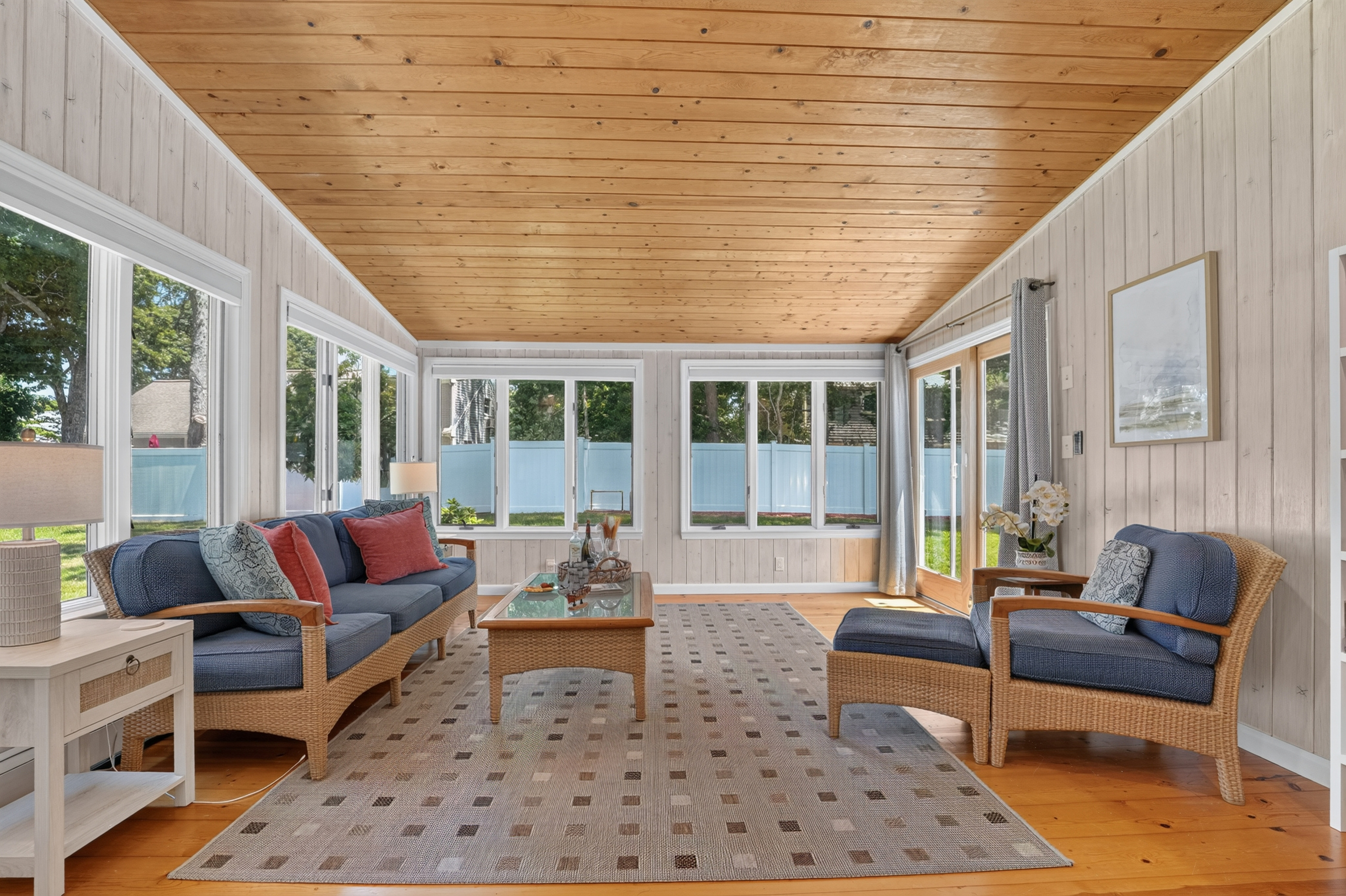 Bright and airy sunroom with comfortable seating for every season.