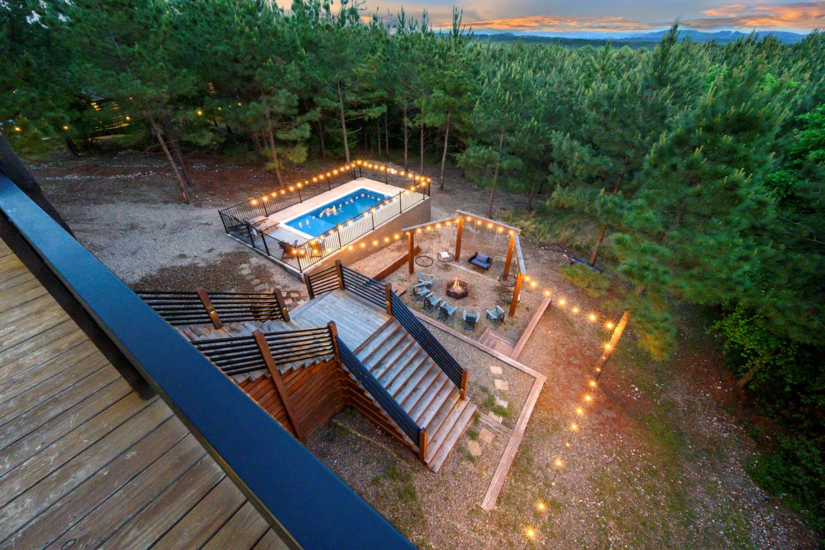Secluded Hochatown cabin surrounded by towering pines with multi-level decks, scenic views, and complete privacy.