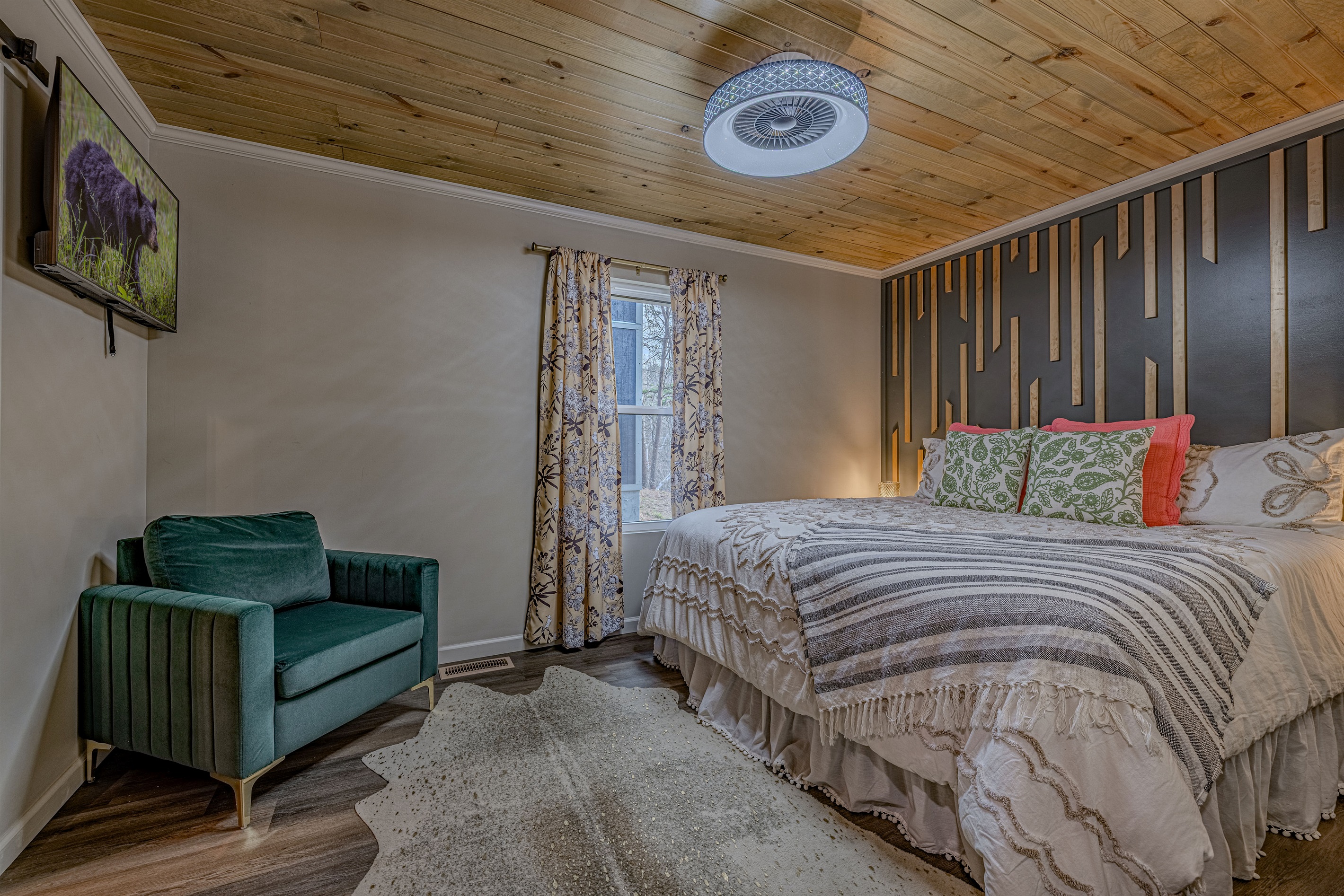 Welcome to your retreat! We love the modern sage barn door leading to the private ensuite bath and the cozy reading nook.