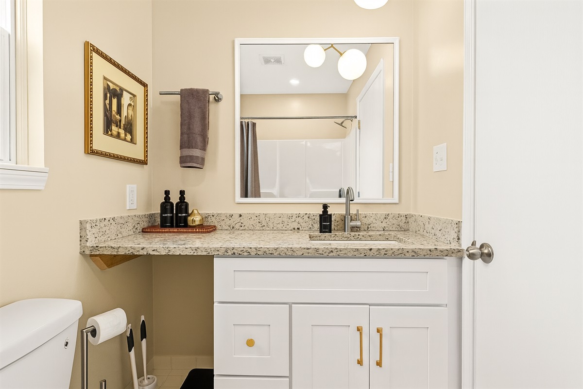 Our bathroom showcases an uncomplicated yet efficient layout, featuring a convenient vanity for your comfort.