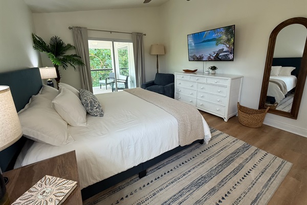 Spacious main floor master suite with room darkening shades and a private balcony
