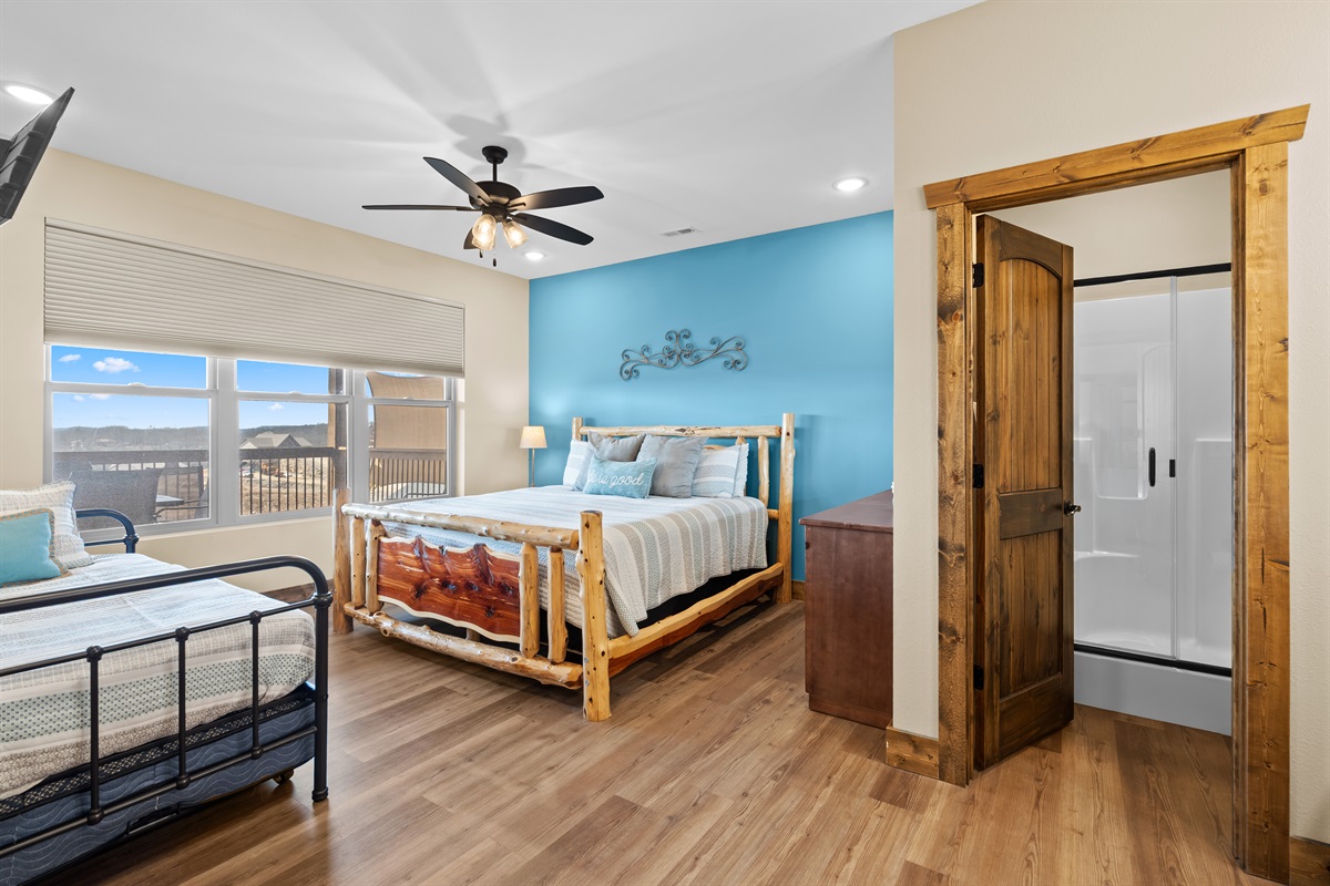 Upper level king bedroom with twin trundle  bed and en suite shower 