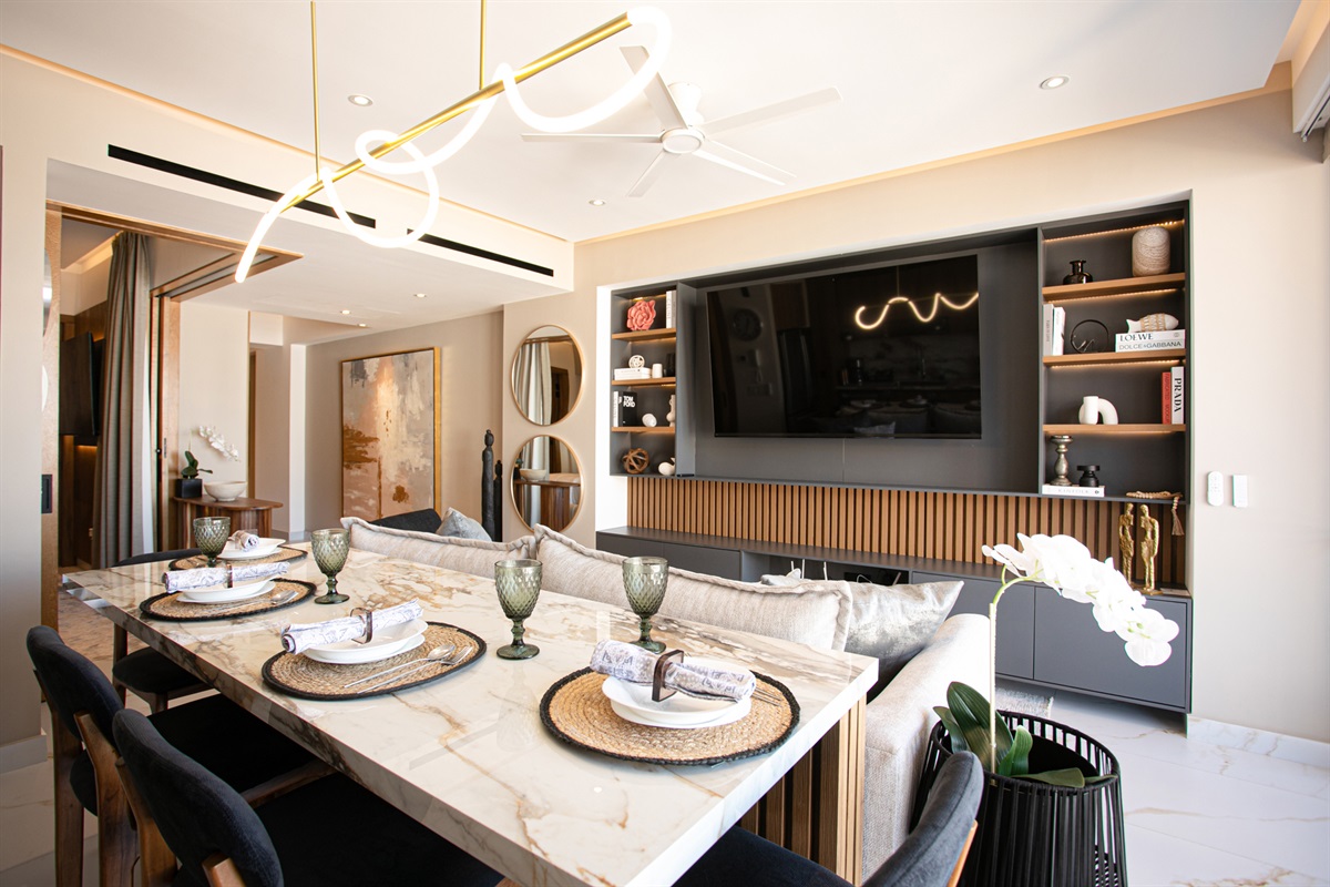 Enjoy meals at the spacious island while catching your favorite shows on the living room’s large smart TV.