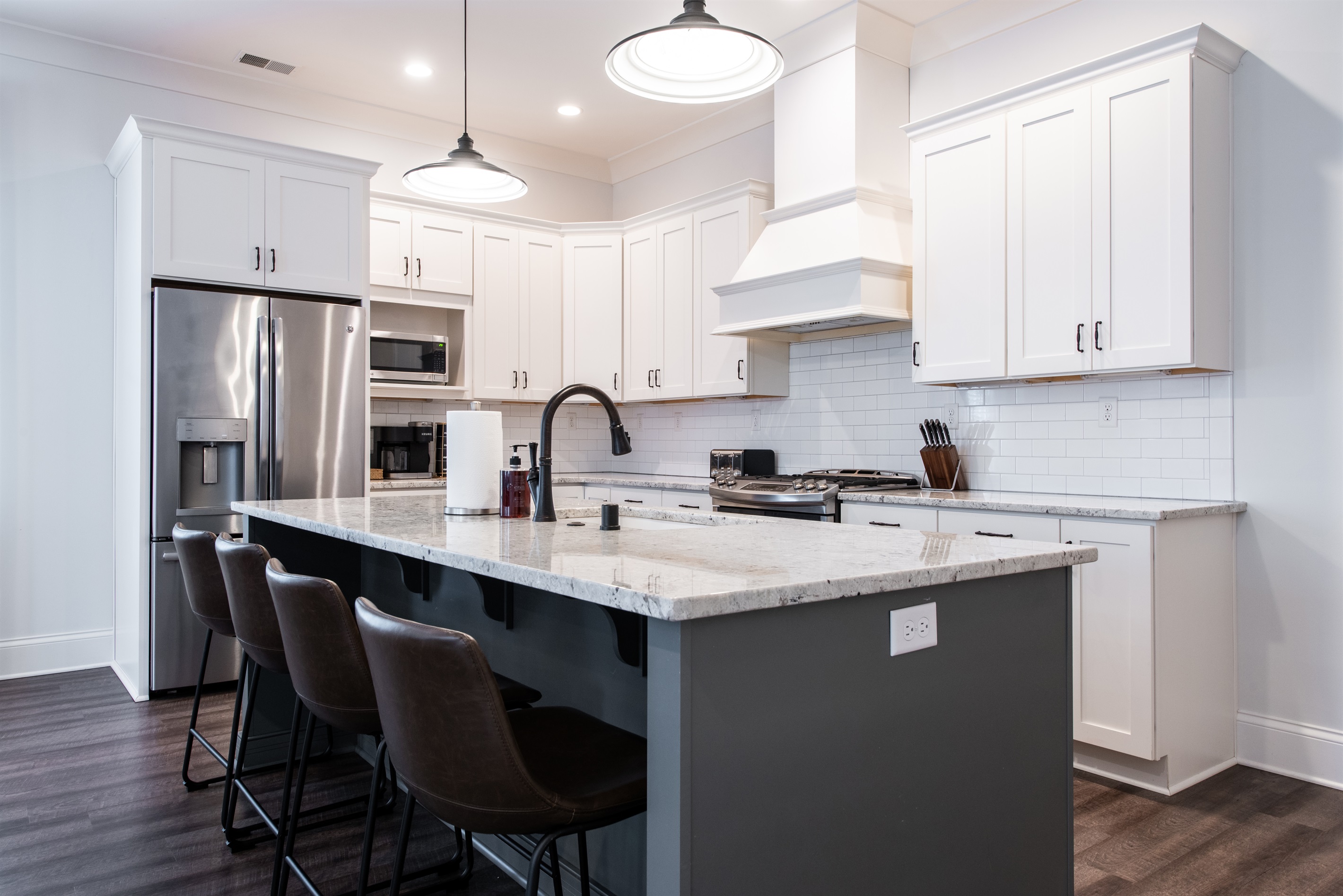 Kitchen island with chairs to seat everyone.