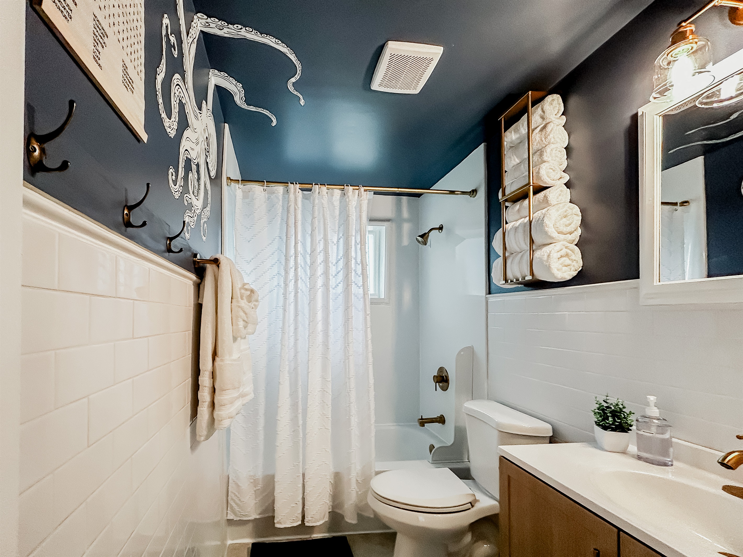 Full Bathroom with Shower, Toilet, Vanity, Towels, Mirror, & More