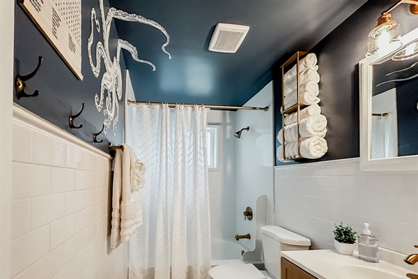 Full Bathroom with Shower, Toilet, Vanity, Towels, Mirror, & More