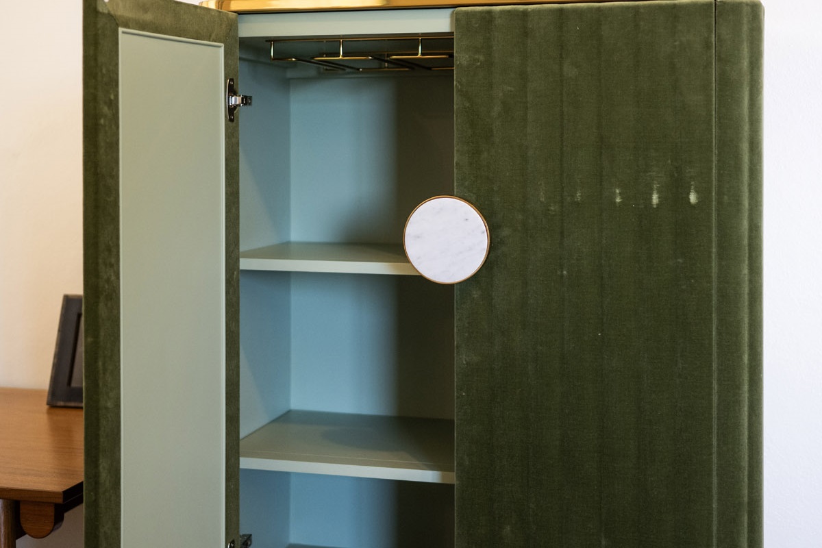 Tuck your clothes away or hang them on the swinging arm next to the bureau.