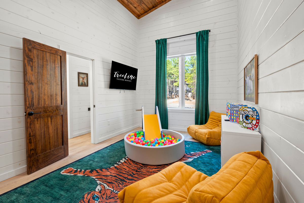 The playroom is designed for endless fun, with games, books, and a ball pit to keep little ones entertained.