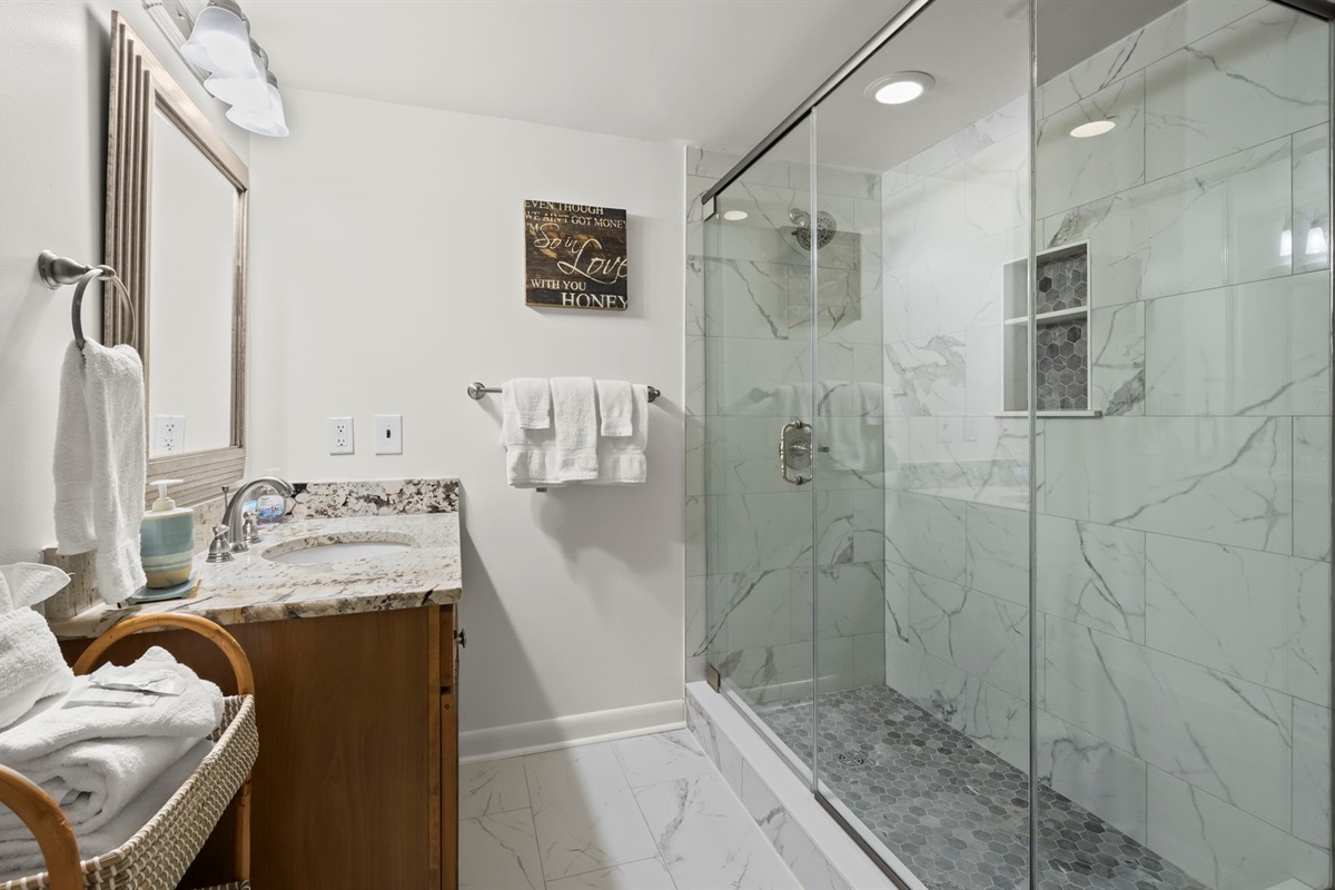 Guests will appreciate the loft en suite in our Cotton Bayou condo, featuring a full, large shower and a modern design. This private bathroom adds comfort and convenience to the spacious loft with double beds.