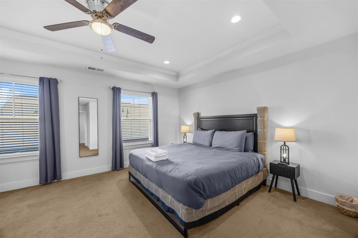 Relax in comfort with a king-size bed, soft lighting, and calming neutral tones.