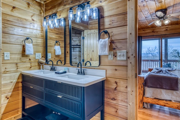 Main-level master bathroom includes double sinks, walk-in shower, jetted tub, separate toilet room, and walk-in closet.