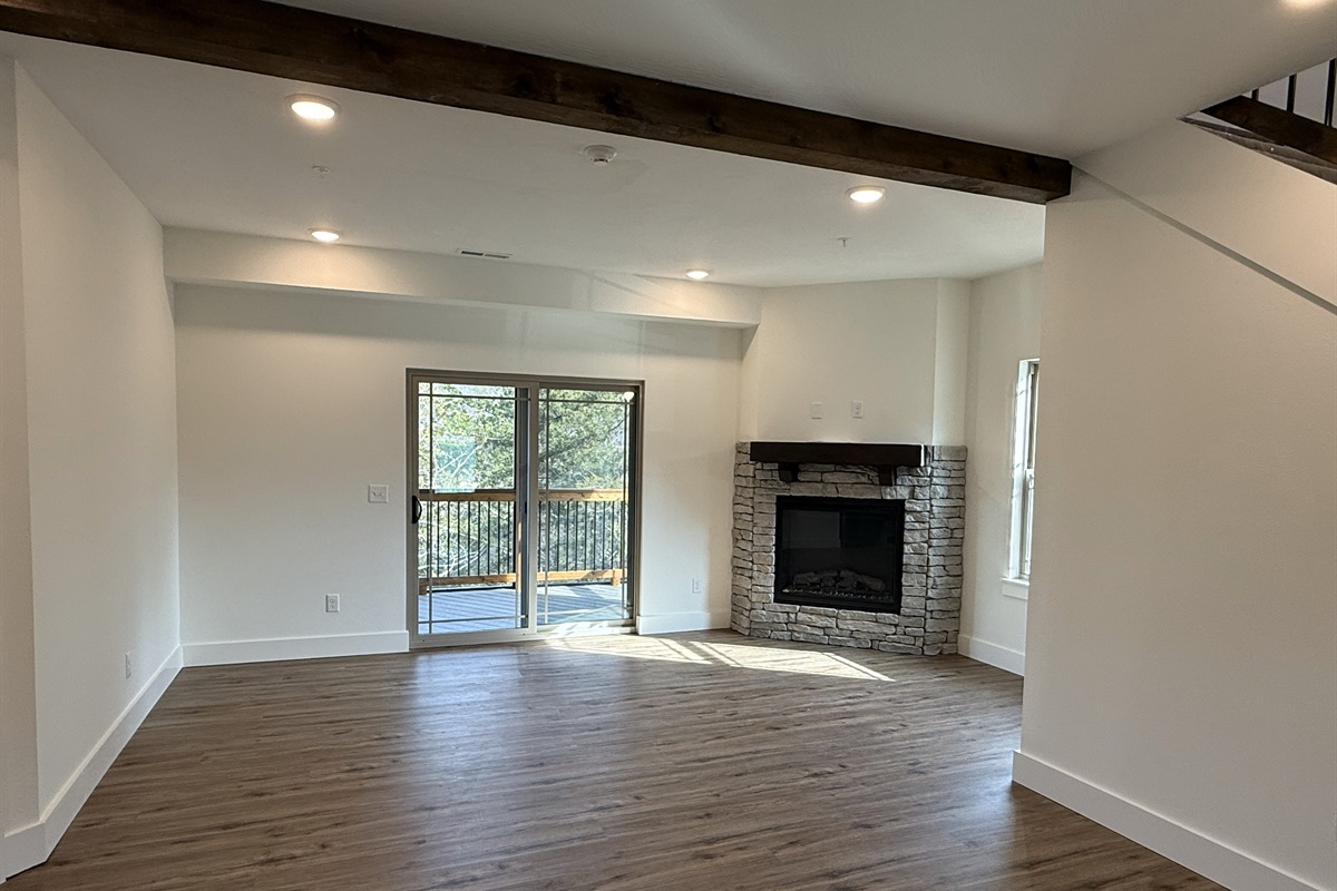 Spacious living area with fireplace and private deck