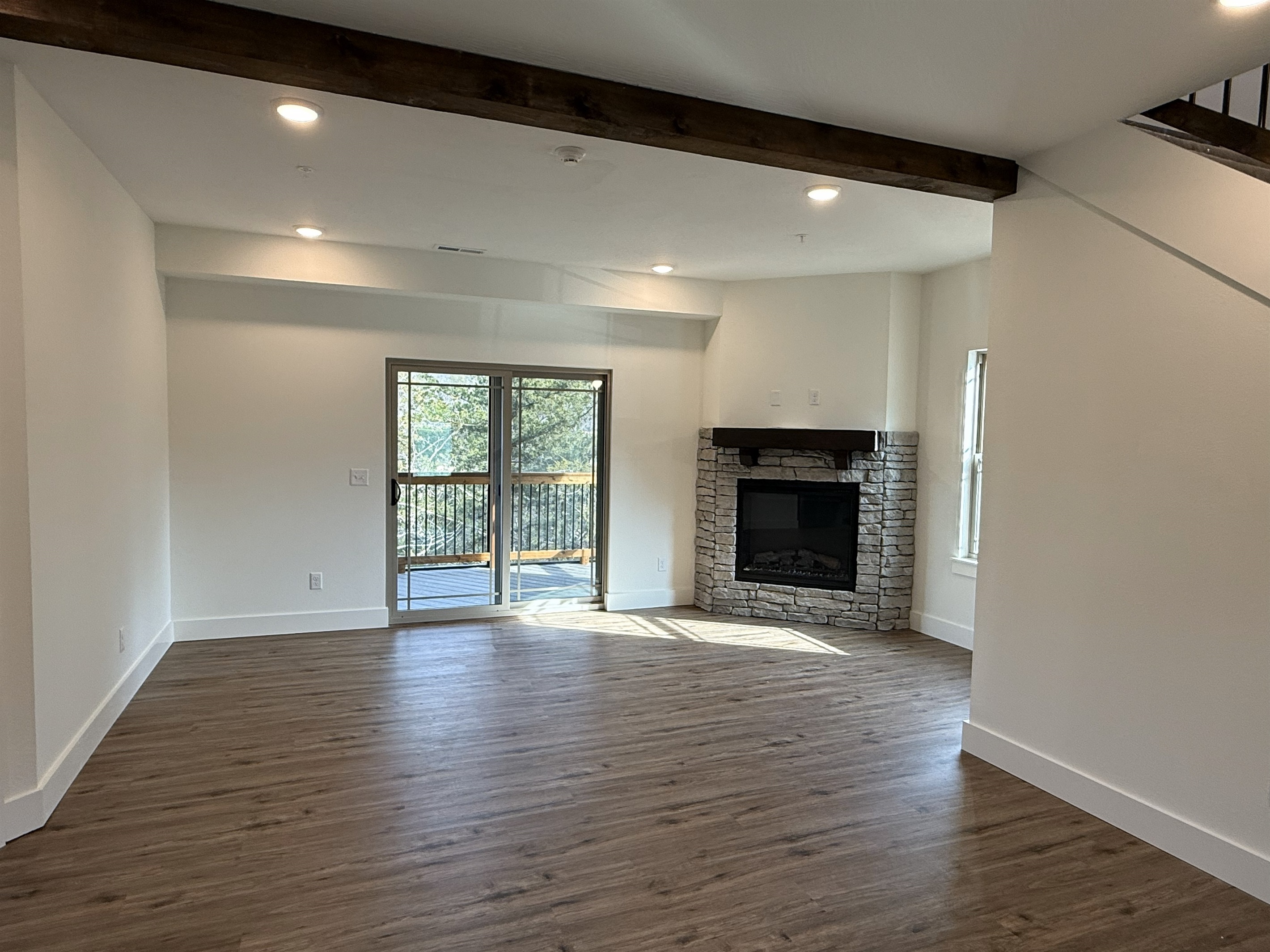Spacious living area with fireplace and private deck