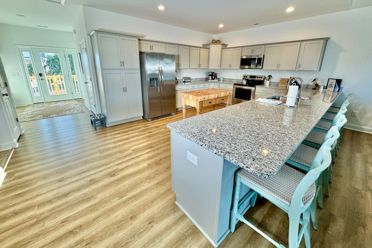 Enjoy cooking in this fully stocked kitchen with a custom island and ample bar seating. 