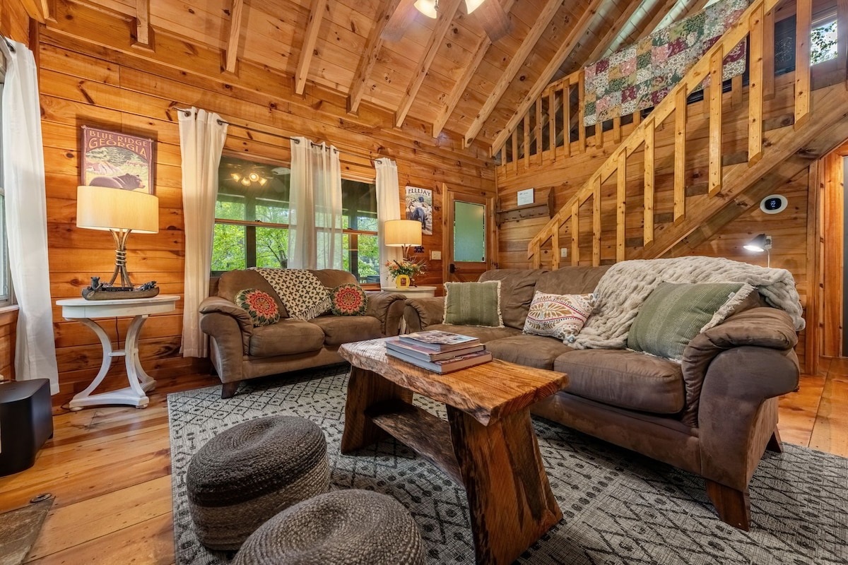 Plenty of comfortable living room seating around the fireplace an TV.