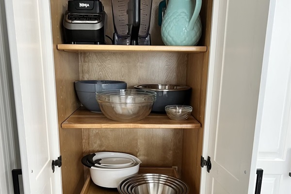 Well-appointed kitchen and pantry featuring numerous appliances for cooking, baking, drinks, and entertaining.